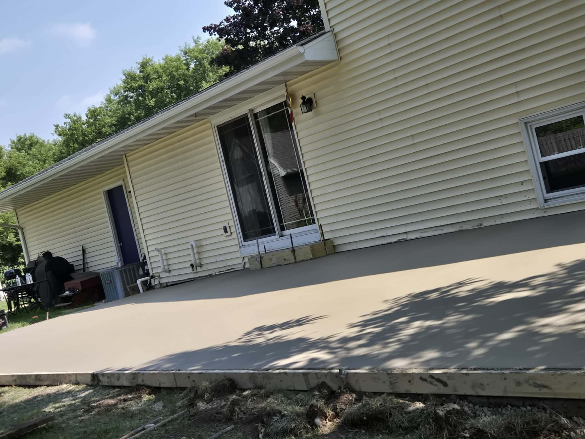 Freshly placed concrete patio slab with forms still set