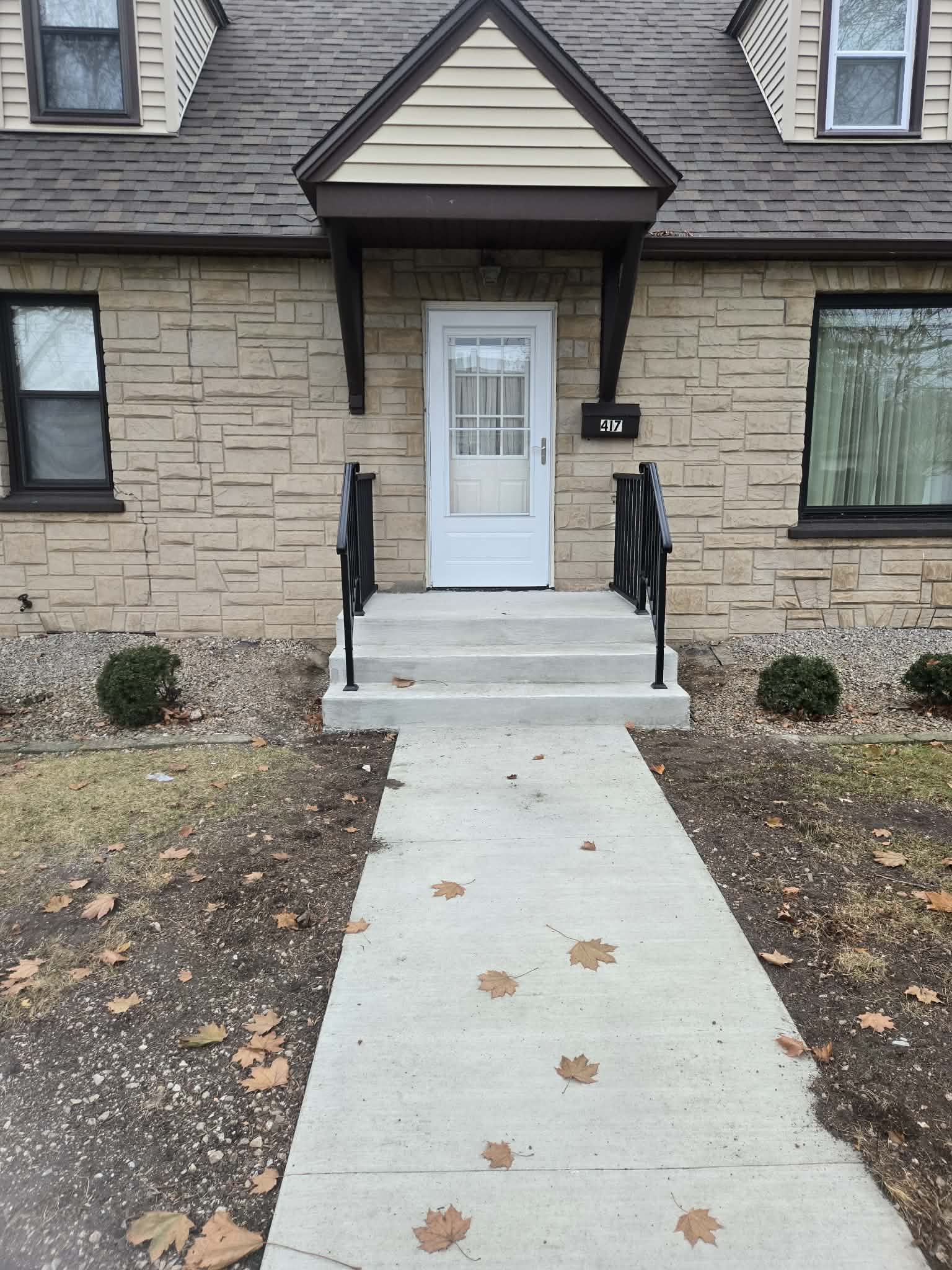New broom-finish front walkway leading to concrete porch steps